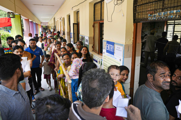 People queue up at a polling booth