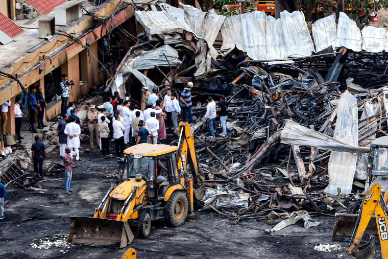Officials inspect the site of a fire accident.