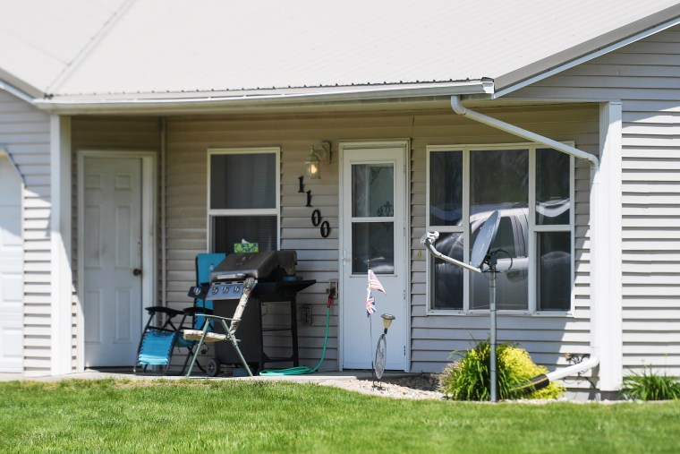 A lawn chair, bbq and satellite dish are seen outside the home