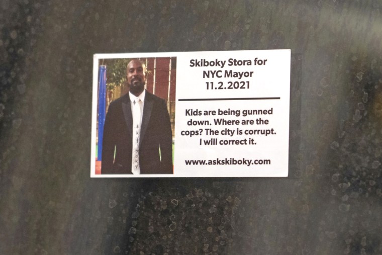 A campaign sticker that says "Skiboky Stora for Mayor of New York" posted in the window of a subway car on the 4 train in New York City