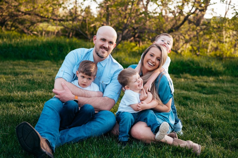 The Shapland family sits on the grass for a portrait