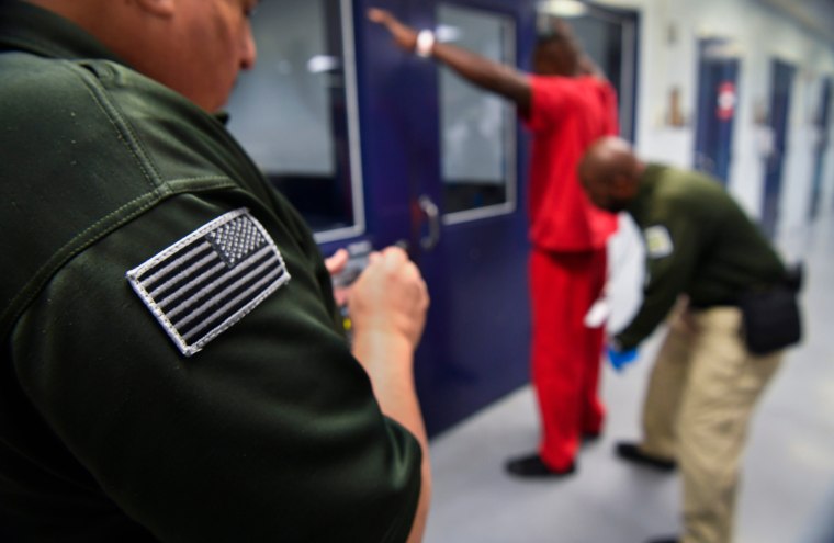 Immigration detainee being searched during processing at the Krome Service Processing Center in Miami.