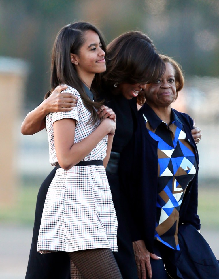 Malia Obama Michelle Obama, and Marian Robinson walk towards Air Force One 