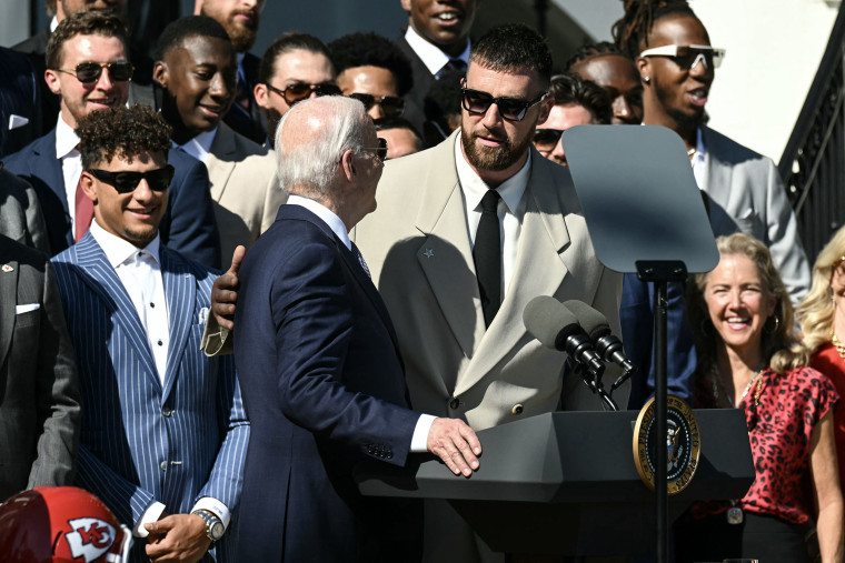 (L-R) Kansas City Chiefs quarterback Patrick Mahomes looks on as US President Joe Biden speaks with Kansas City Chiefs tight end Travis Kelce during a celebration for the Kansas City Chiefs, 2024 Super Bowl champions, on the South Lawn of the White House in Washington, DC, on May 31, 2024. 