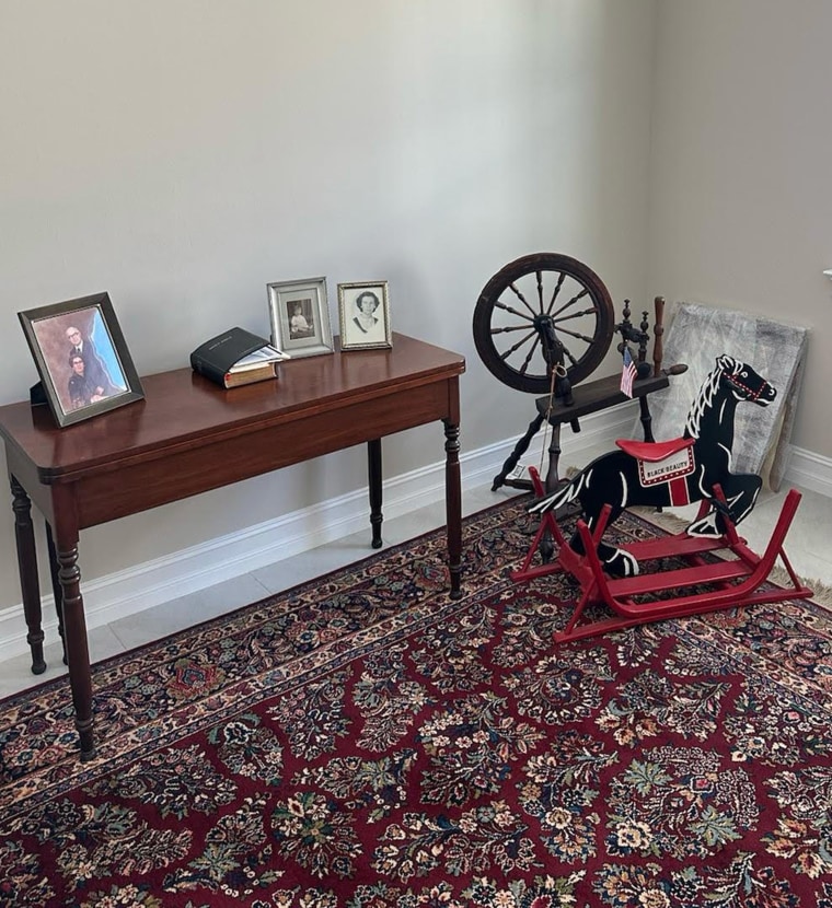 spinning wheel in living area with other old furniture 