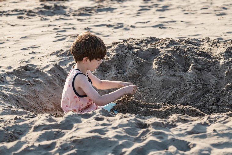 Boy Digging at Beach