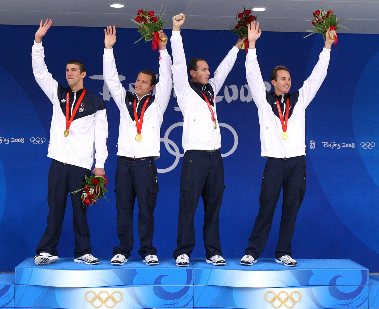 Michael Phelps, Brendan Hansen, Jason Lezak and Aaron Piersol on podium after winning Olympic gold medals in 2008.