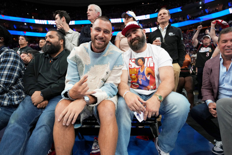 Travis Kelce and Jason Kelce attend a basketball game in 2023.