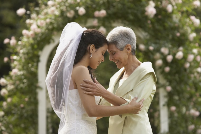 Bride and mother touching foreheads