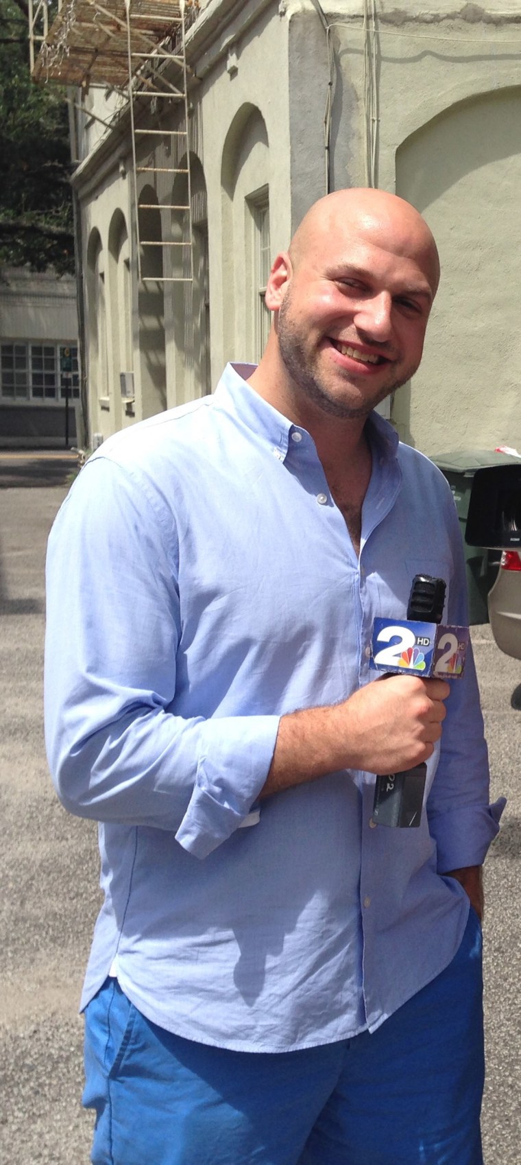 photo of yosef holding an nbc mic. This image was taken before he got into running 