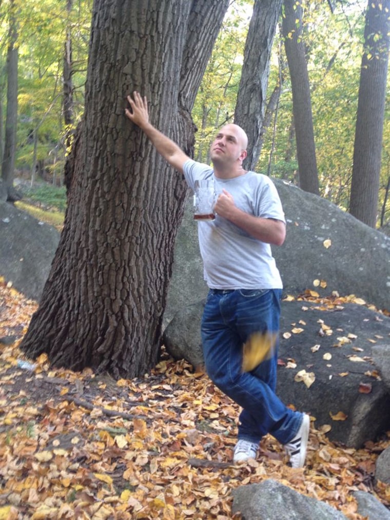 photo of yosef leaning agains a tree drinking a beer. This image was taken before he got into running 