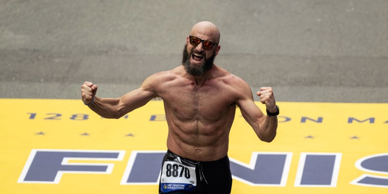 yosef crossing the finish line of a race with his fist in the air