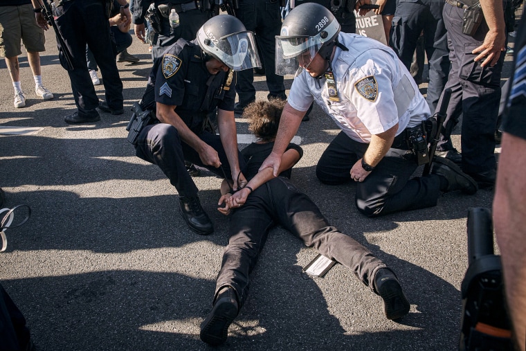 Police detain a pro-Palestine protester.