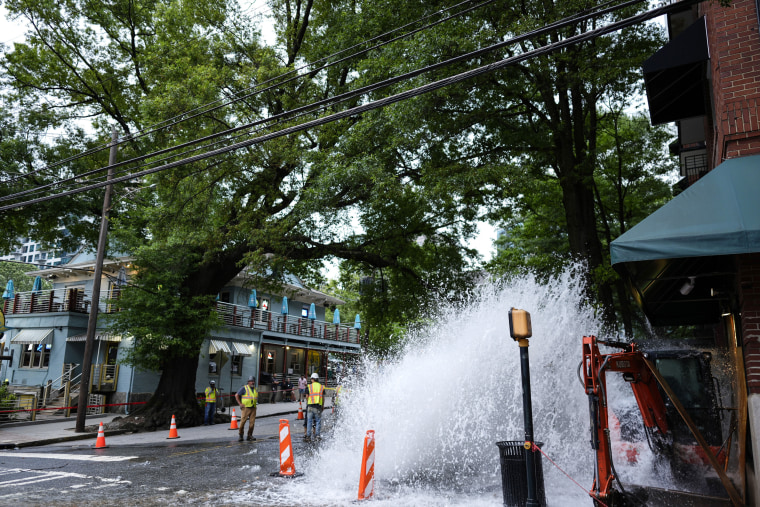 Water gushes out of a broken water transmission line in downtown Atlanta