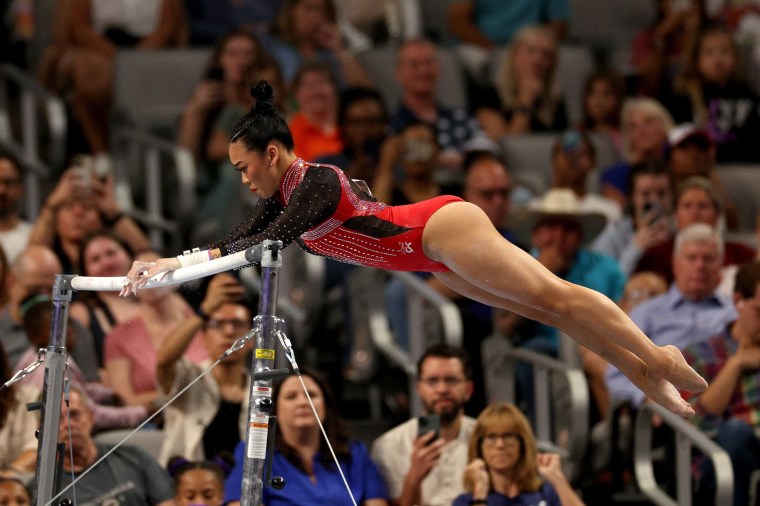 Suni Lee competes on the uneven bars.