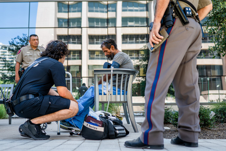 A medic assists a patient.