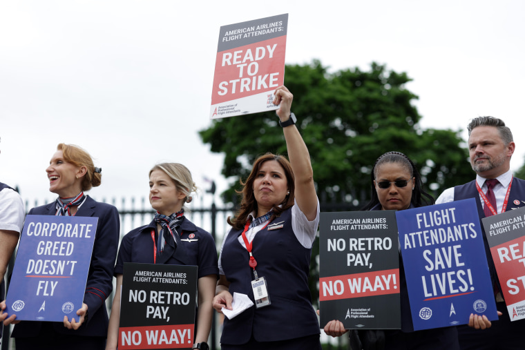 American Airlines flight attendants hold signs and picket outside the White House