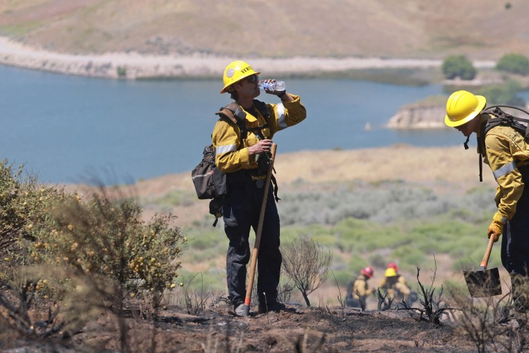 A Los Angeles firefighter takes a drink of water 