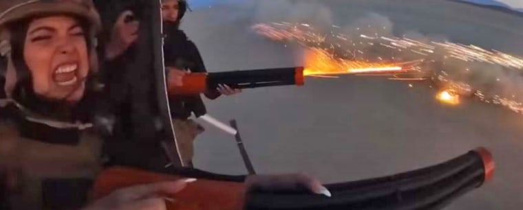 Two women shoot fireworks from a helicopter in the video "Destroying a Lamborghini With Fireworks."