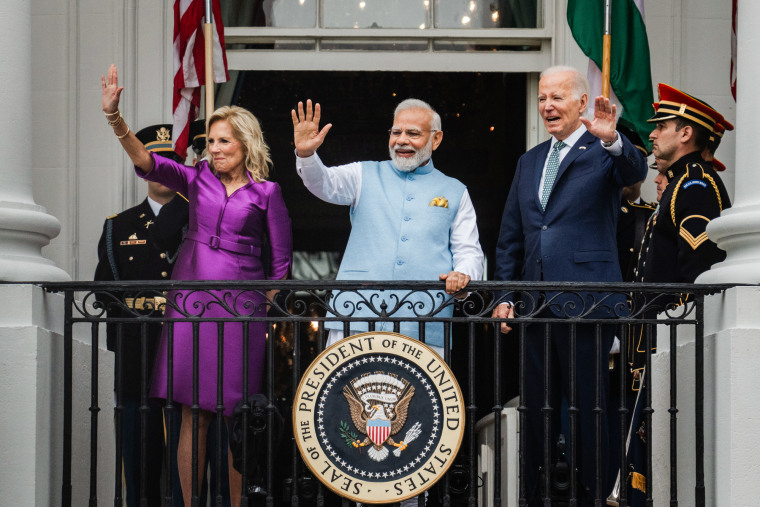 Jill Biden, Narendra Modi, and Joe Biden wave from the terrace of the White House