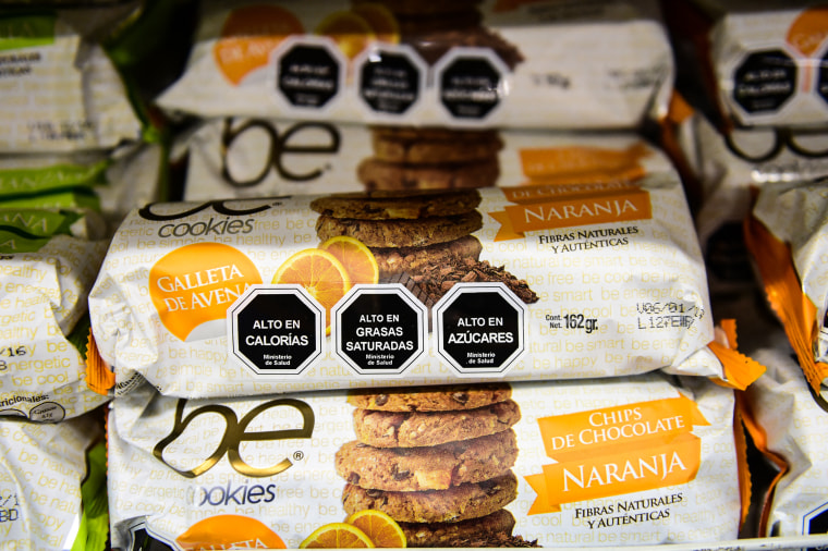 Cookies with labels stating high sugar, calorie and saturated fat content