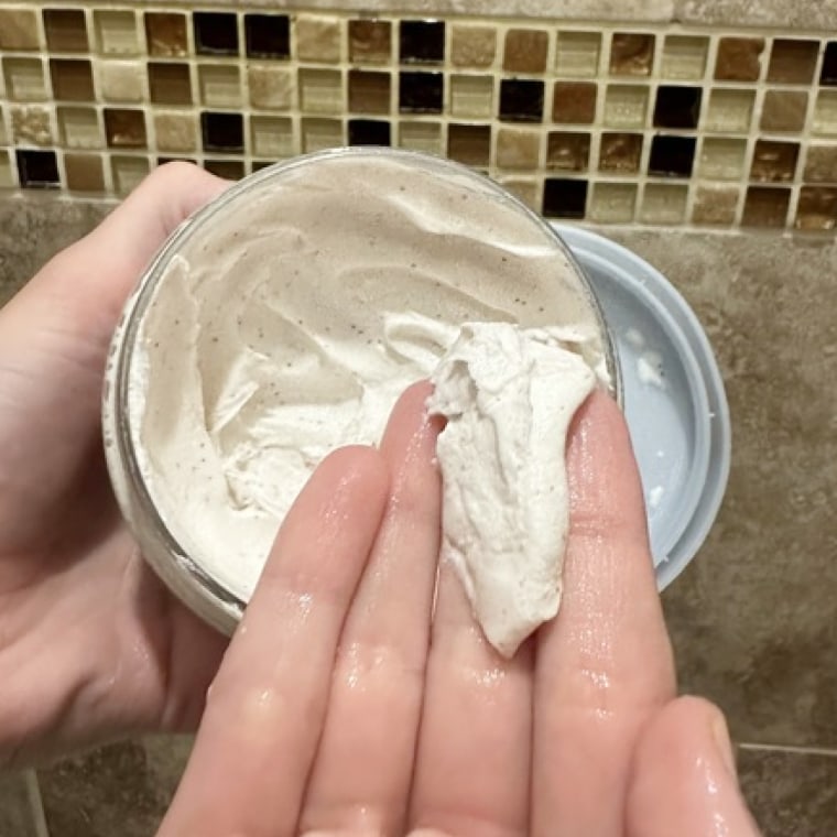 NBC Select updates editor Mili Godio scoops out Dove’s Exfoliating Body Polish, revealing its thick consistency and tiny crushed macadamia incorporated.