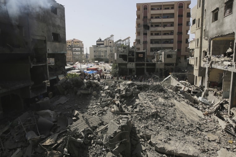 Palestinians inspect the destruction following an Israeli Special Forces operation in the Nuseirat camp on June 8, 2024.