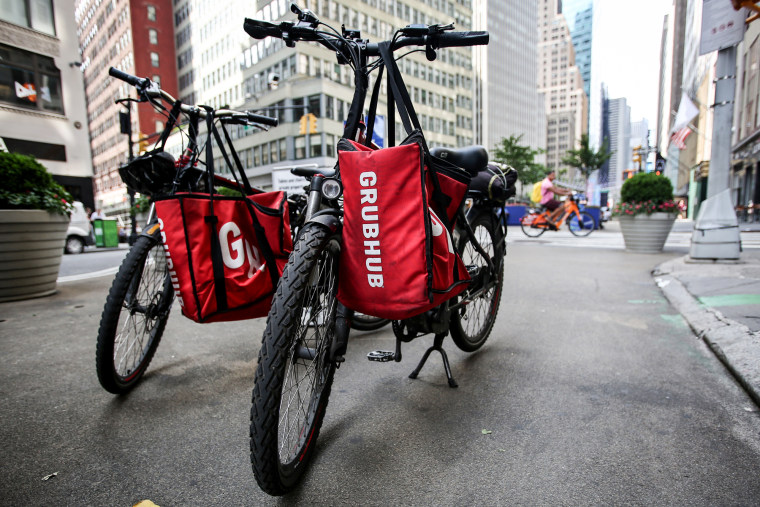 Bikes with GrubHub bags sit on the street
