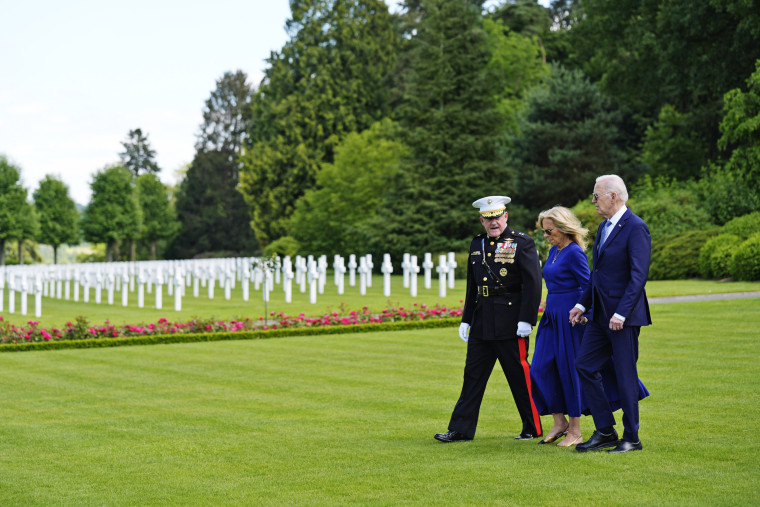 President Joe Biden and first lady Jill Biden walk with Maj. Gen. Robert B. Sofge Jr. as they attend a wreath-laying ceremony