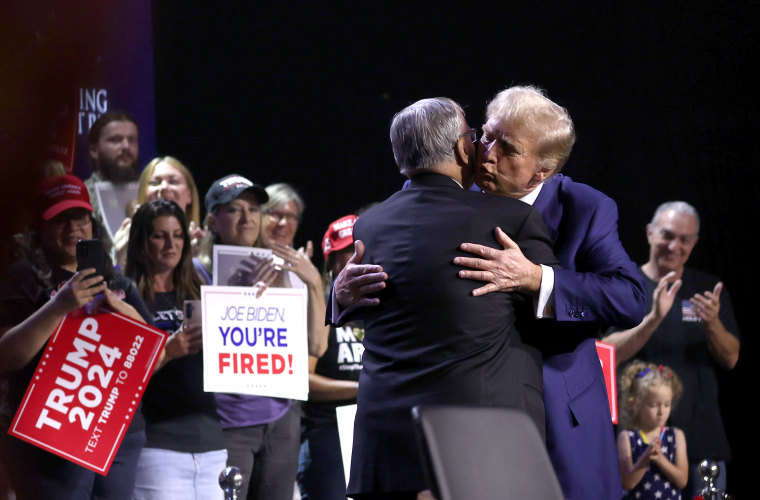 Donald Trump, right, hugs Joe Arpaio during a Turning Point PAC town hall at Dream City Church in Phoenix