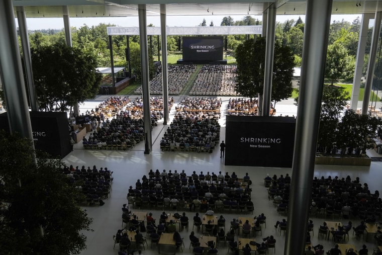 Image: Attendees watching a presentation during an announcement of new products on the Apple campus