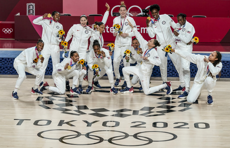 United States women basketball players pose with their gold medals 