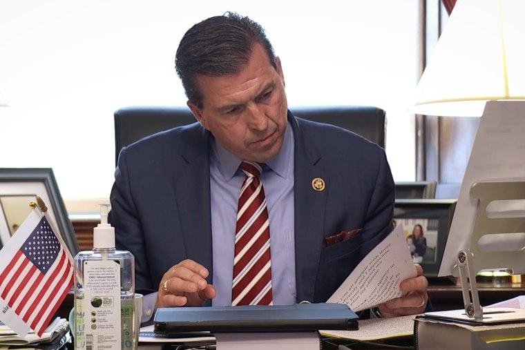 U.S. Rep. Kevin Mullin at his desk reading a document.