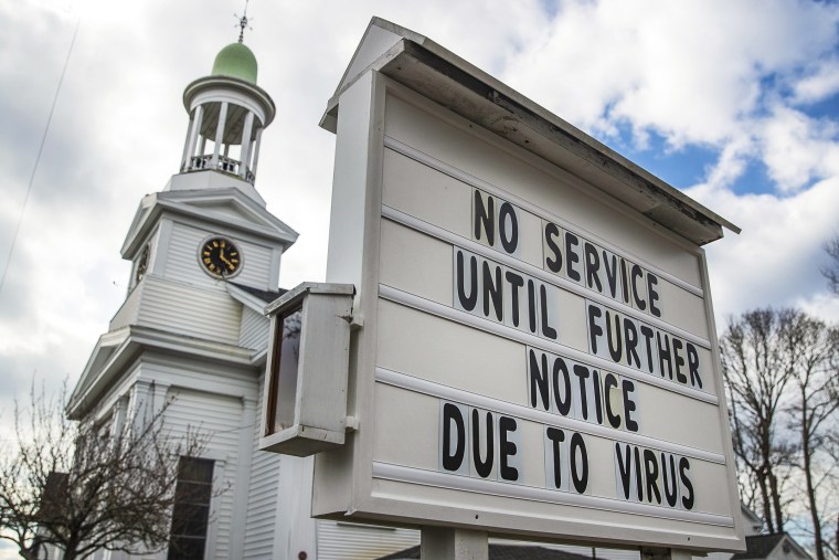 A "No Service Until Further Notice Due To Virus" sign stands outside a church 