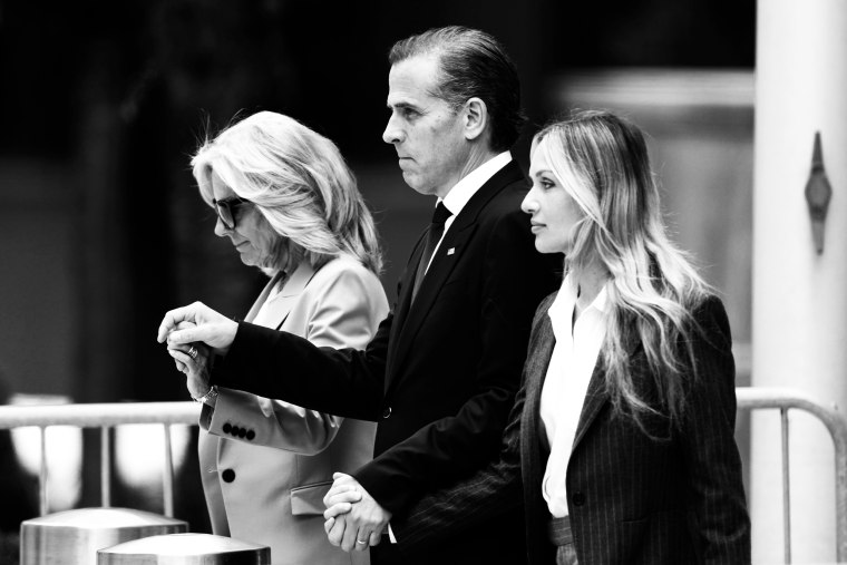 Hunter Biden holds his wife and mother's hands as they walk out of the courthouse