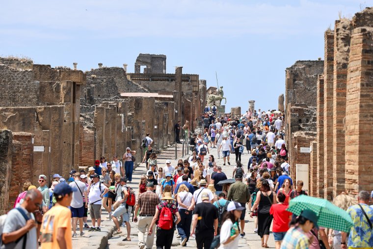 Crowd of tourists on the main street of the Pompeii