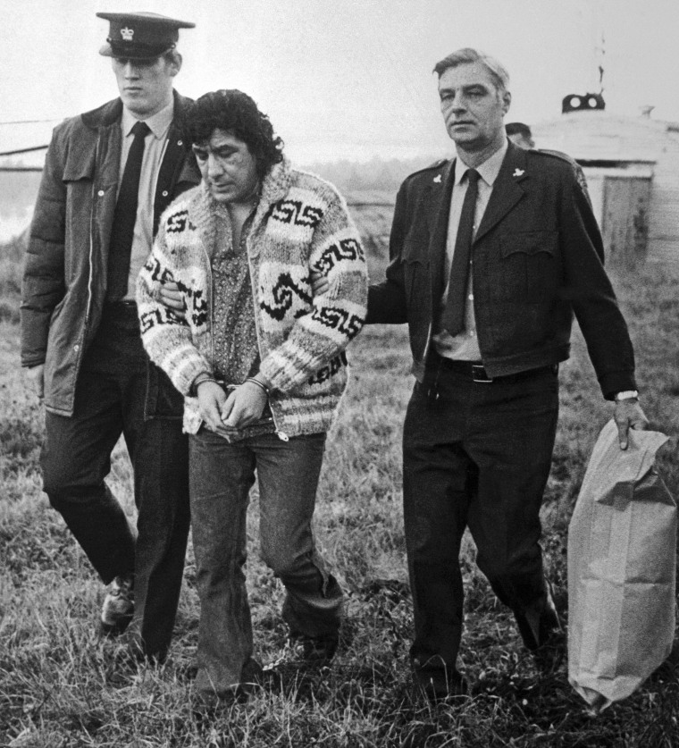 Law enforcement officers handcuffed Leonard Peltier