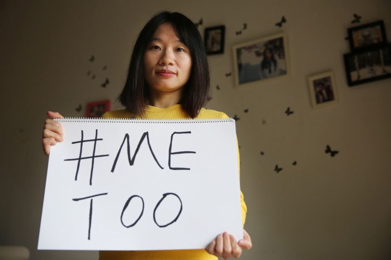 Huang Xueqin poses with a #MeToo sign at her home in 2017