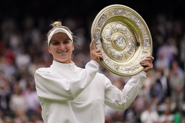 Czech Republic's Marketa Vondrousova holds the trophy after beating Tunisia's Ons Jabeur to win the final of the women's singles at Wimbledon