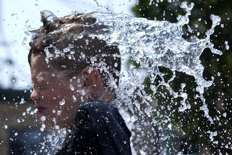 A boy cools off at a fountain during in Chicago.
