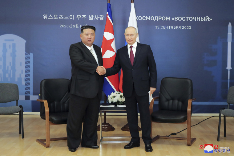 Kim Jong Un, left, and Vladimir Putin shake hands before their talk at the Vostochny cosmodrome outside the city of Tsiolkovsky, Russia