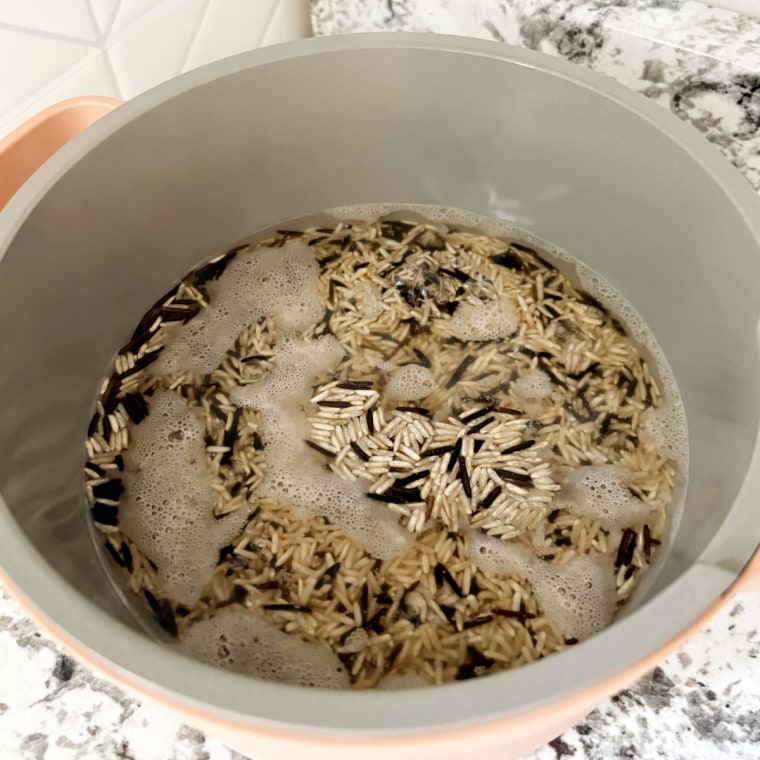 Rice and boiling water in the Our Place Perfect Power Pot.