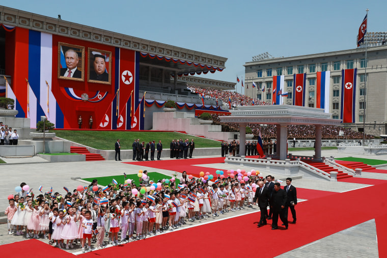 North KoreaN leader Kim Jong Un and Russian President Vladimir Putin walk past children attend a welcoming ceremony at Kim Il Sung Square in Pyongyang on June 19, 2024.