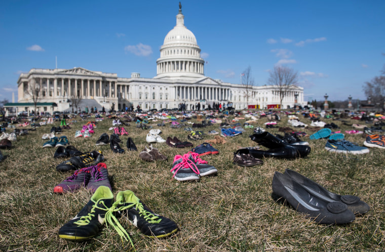 The lawn outside the Capitol is covered with 7,000 pairs of empty shoes 