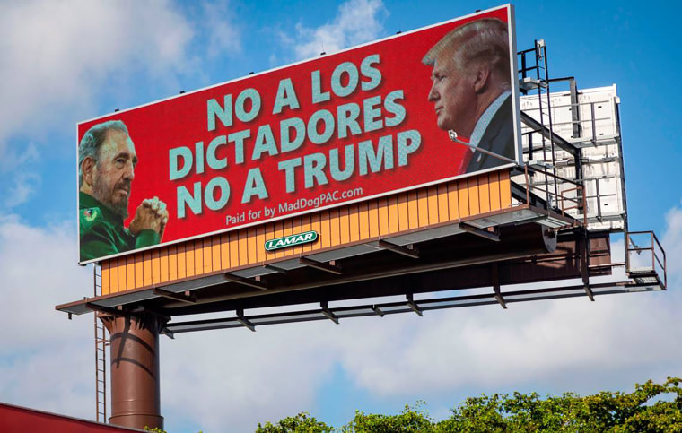 A billboard located on the Palmetto Expressway and Northwest 67th Avenue in Miami-Dade County shows images of Fidel Castro and Donald Trump and tells voters to avoid dictators, in Miami