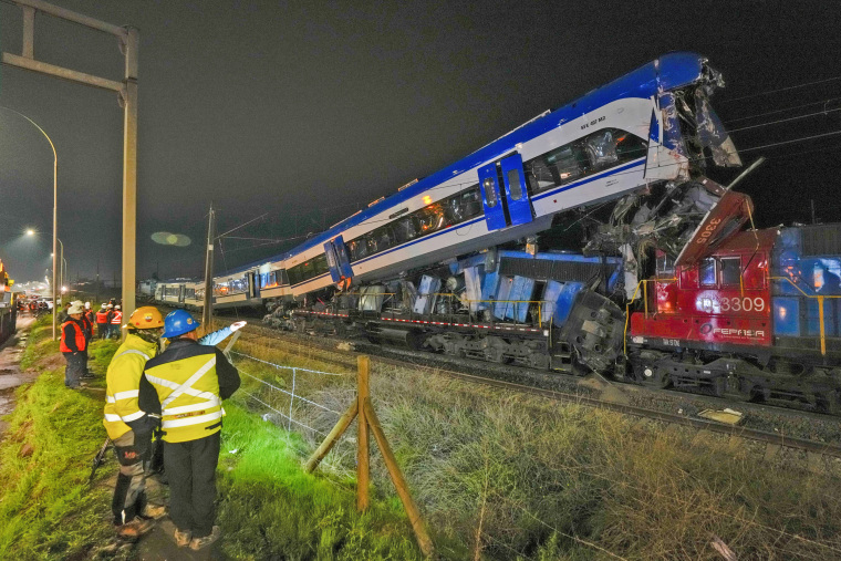 Police inspect two trains that collided in Santiago, Chile, Thursday, June 20, 2024. 