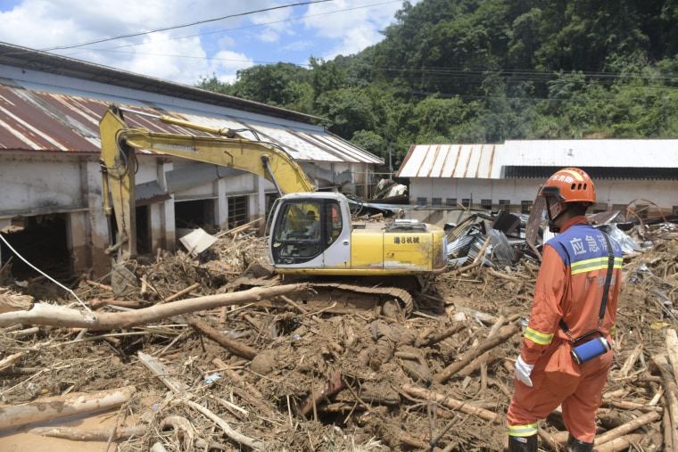 A bulldozer clears flood debris in Meizhou City, China