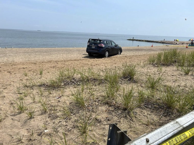This photo provided by the West Haven Police Department shows a vehicle that was on Prospect Beach off of Prospect Ave in West Haven, Conn., on Saturday.