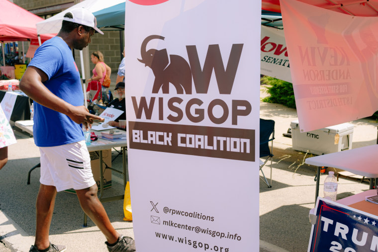 A sign reads "WISGOP Black Coalition" with a black elephant logo