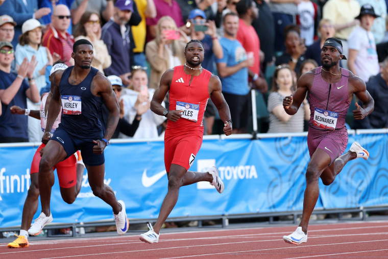 Fred Kerley, Noah Lyles and Kenny Bednarek cross the finish line in the men's 100-meter final.